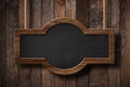 Blackboard with rounded shape hanging on ropes with wood planks background