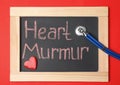 Blackboard with text HEART MURMUR and stethoscope Royalty Free Stock Photo