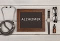 blackboard with text & x22;Alzheimer& x22;, eyeglasses, watch and stethoscope Royalty Free Stock Photo