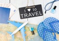 blackboard with text & x22;I LOVE TO TRAVEL& x22;, plane, map, passport, money, flops and other accessories Royalty Free Stock Photo