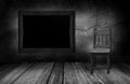 Blackboard and wood chair in interior room with gray stone wall Royalty Free Stock Photo