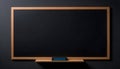 a blackboard with a wooden frame mounted on black wall Royalty Free Stock Photo