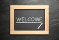Blackboard with word WELCOME and chalk on slate background, top view Royalty Free Stock Photo