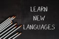 A blackboard with the words learn new languages written on it Royalty Free Stock Photo