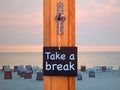 Blackboard with words Take A Break in front of beach Royalty Free Stock Photo