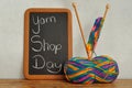 A blackboard with he words Yarn Shop Day