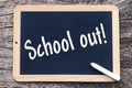 On a blackboard is written with chalk: School out Royalty Free Stock Photo