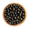 Blackcurrant berries, black currant berries, cassis, in a wooden bowl