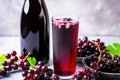 blackcurrant soda in a glass bottle beside a bunch of fresh blackcurrants Royalty Free Stock Photo
