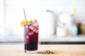 blackcurrant soda in a tall glass with a twist of lemon peel