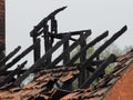 Blackened roof rafters of a burned down residential building after a fire Royalty Free Stock Photo