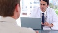 Blackhaired doctor talking with his patient