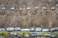 Blackhouse thatched roof detail with thatch, stone and rope Royalty Free Stock Photo