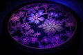 blacklight-illuminated cherry blossom mandala, with its intricate pattern brought to life in the dark