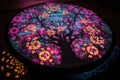 blacklight-illuminated cherry blossom mandala, with its intricate pattern brought to life in the dark