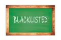 BLACKLISTED text written on green school board