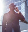 A blackman in a suit speaking on smartphone. Royalty Free Stock Photo