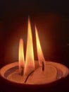Burning three candles in the dark. Blurred of candles light abstract background.