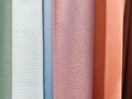 Blackout curtain samples. Multicolored cotton textile texture. Suit poly viscose fabric. Shop window Royalty Free Stock Photo