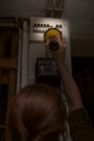 Blackout, electricity cut, woman with flashlight checking the br Royalty Free Stock Photo