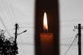 Blackout, power grid overloaded. Blackout concept. Earth hour. Burning flame candle and power lines on background Royalty Free Stock Photo