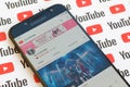 Blackpink official youtube channel on smartphone screen on paper youtube background