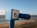 Old fashioned seaside coin operated telescope above the beach looking out to sea in blackpool lancashire