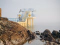 Blackrock public diving tower in Salthil area of Galway in a fog. Tourists on a top of the tower