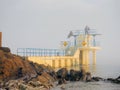 Blackrock public diving tower in Salthil area of Galway in a fog. Tourists on a top of the tower