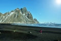 Blacksand beach with mountains in the background Royalty Free Stock Photo