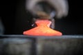 Blacksmith and anvil. Blacksmith working with red hot metal workpiece of new hammer on the anvil at the forge Royalty Free Stock Photo