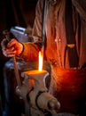 Blacksmith bending a hot metal rod Royalty Free Stock Photo