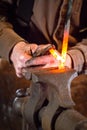 Blacksmith bending a hot metal rod Royalty Free Stock Photo