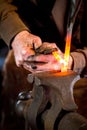 Blacksmith bending a hot metal rod Royalty Free Stock Photo