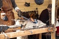 Blacksmith blows the bellows Royalty Free Stock Photo