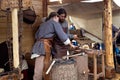 Blacksmith blows the bellows