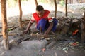 Blacksmith boy hammering and creating souvenirs for tourists