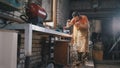 Blacksmith checks the thickness of the sharpening