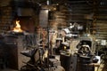 Blacksmith decorative elements hanging at forge, workshop. Royalty Free Stock Photo