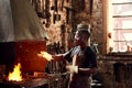 Blacksmith, fire and a black man welding metal in a workshop for manufacturing or industrial design. Factory, melting or