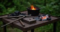 Blacksmith forge and tools with glowing coals and flames in outdoor setting Royalty Free Stock Photo