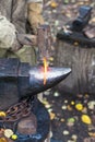 Blacksmith forges red glowing iron rod on anvil Royalty Free Stock Photo