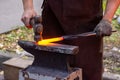 Blacksmith forging glowing metal with a hammer on an anvil Royalty Free Stock Photo