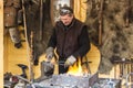Blacksmith forging a horseshoe at the Christmas fair in Warsaw
