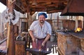 Blacksmith Forging Metal with Hammer