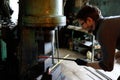 Blacksmith forging by using pneumatic hammer.