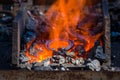 blacksmith furnace with burning coals, tools, and glowing hot horseshoe Royalty Free Stock Photo