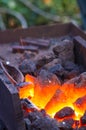 blacksmith furnace with burning coals, tools, and glowing hot metal workpieces Royalty Free Stock Photo