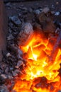 blacksmith furnace with burning coals, tools, and glowing hot metal workpieces Royalty Free Stock Photo