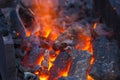 blacksmith furnace with burning coals, tools, and glowing hot metal workpieces Royalty Free Stock Photo